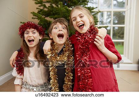 Children playing with Christmas tinsel View Large Photo Image Stock Image - Children playing with Christmas tinsel. Fotosearch