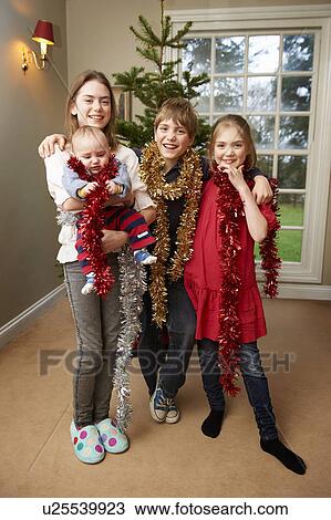Children playing with Christmas tinsel View Large Photo Image Stock Image - Children playing with Christmas tinsel. Fotosearch
