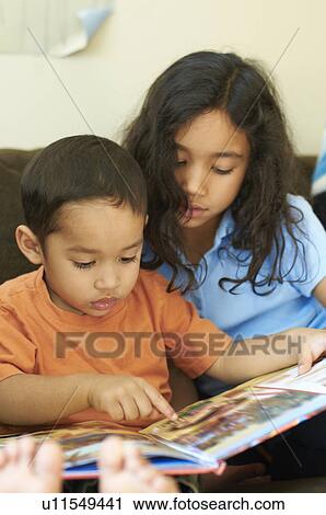Children reading together on sofa View Large Photo Image Stock Image - Children reading together on sofa. Fotosearch