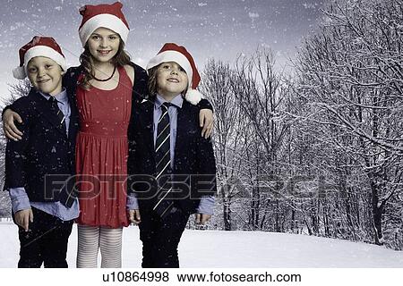 Children wearing Santa hats in snow View Large Photo Image Stock Photo - Children wearing Santa hats in snow. Fotosearch