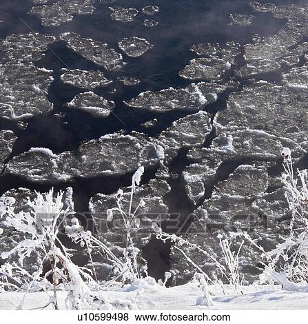 Stock Photo - Chunks of ice on freezing river. Fotosearch