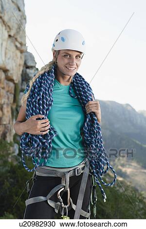 Climber holding coiled rope on mountain View Large Photo Image Stock Image - Climber holding coiled rope on mountain. Fotosearch