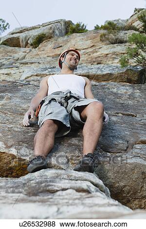 Climber leaning on steep rock face View Large Photo Image Stock Photo - Climber leaning on steep rock face. Fotosearch
