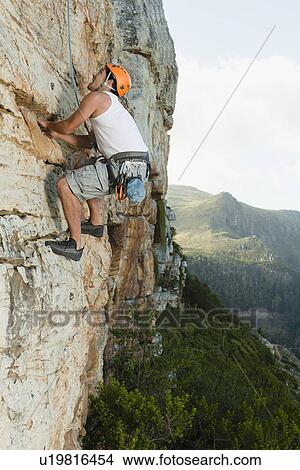 Climber scaling steep rock face View Large Photo Image Picture - Climber scaling steep rock face. Fotosearch