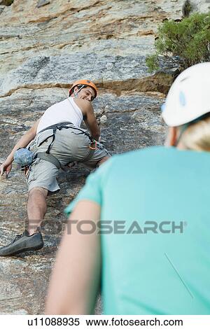 Climbers scaling steep rock face View Large Photo Image Stock Photography - Climbers scaling steep rock face. Fotosearch