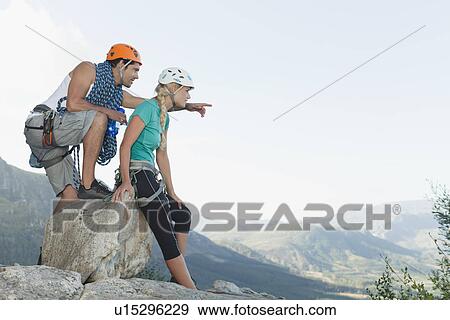 Stock Photo - Climbers surveying climb down. Fotosearch