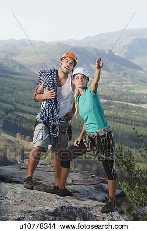 Picture - Climbers surveying mountaintop. Fotosearch