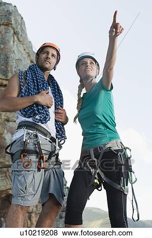 Stock Photo - Climbers surveying mountaintop. Fotosearch