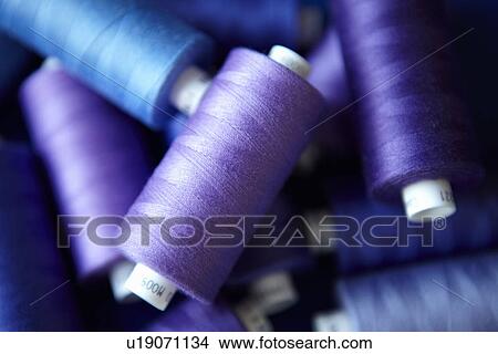 Picture - Close up of blue spools of thread. Fotosearch