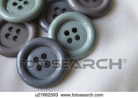 Stock Image - Close up of grey buttons. Fotosearch