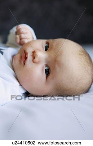 Close up of infant on bed View Large Photo Image Stock Image - Close up of infant on bed. Fotosearch