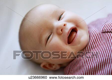 Close up of infants smiling face View Large Photo Image Stock Image - Close up of infants smiling face. Fotosearch