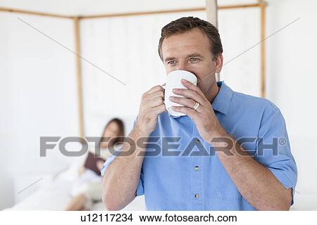 Picture - Close up of man drinking coffee. Fotosearch