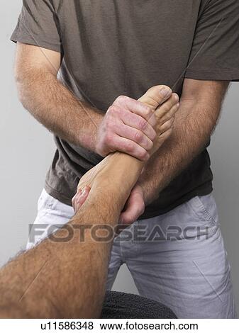 Stock Photo - Close up of man having foot massage. Fotosearch
