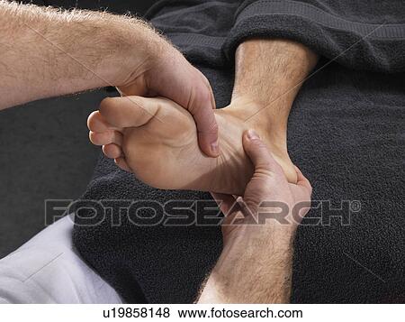 Stock Photo - Close up of man having foot massage. Fotosearch
