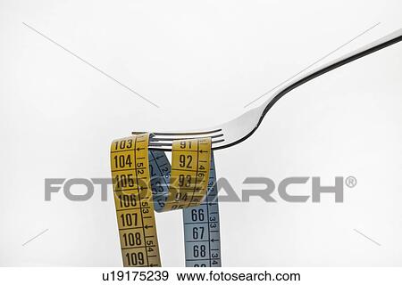 Close up of measuring tape on fork View Large Photo Image Stock Photo - Close up of measuring tape on fork. Fotosearch