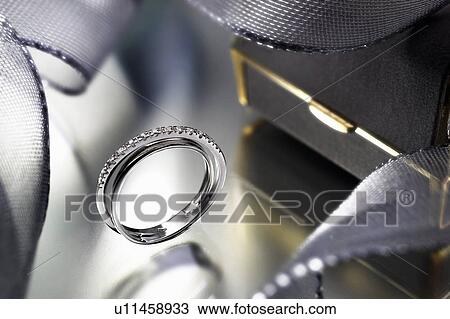 Stock Image - Close up of modern engagement ring. Fotosearch