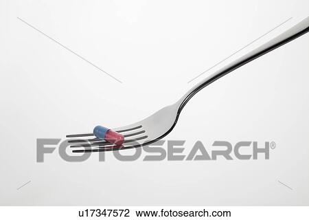 Close up of pill balanced on fork View Large Photo Image Stock Image - Close up of pill balanced on fork. Fotosearch