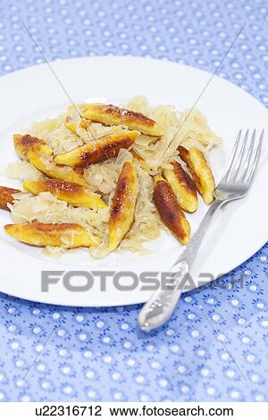 Stock Image - Close up of plate of schupfnudel. Fotosearch