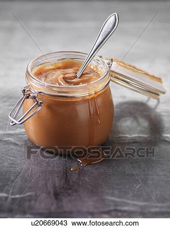 Stock Image - Close up of pot of caramel sauce. Fotosearch