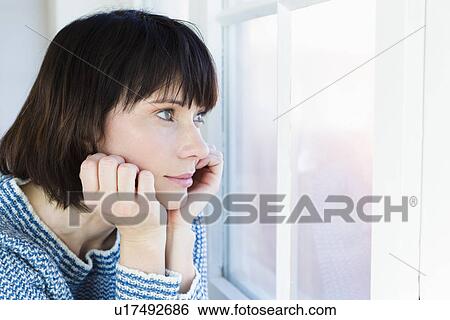 Close up of woman resting chin in hands View Large Photo Image Stock Photograph - Close up of woman resting chin in hands. Fotosearch