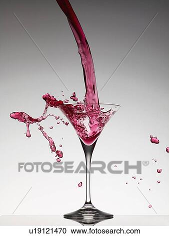 Cocktail pouring into martini glass View Large Photo Image Stock Image - Cocktail pouring into martini glass. Fotosearch