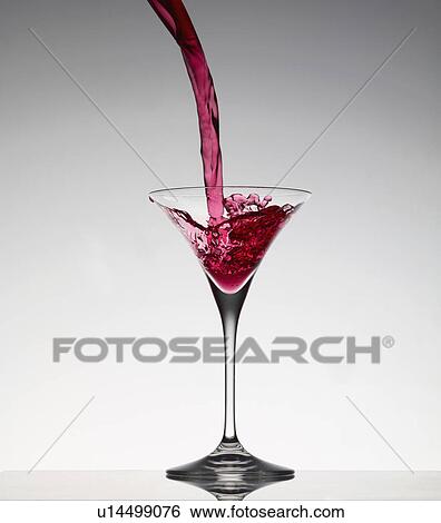 Cocktail pouring into martini glass View Large Photo Image Stock Photograph - Cocktail pouring into martini glass. Fotosearch