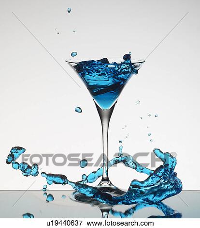 Cocktail splashing around martini glass View Large Photo Image Stock Photo - Cocktail splashing around martini glass. Fotosearch