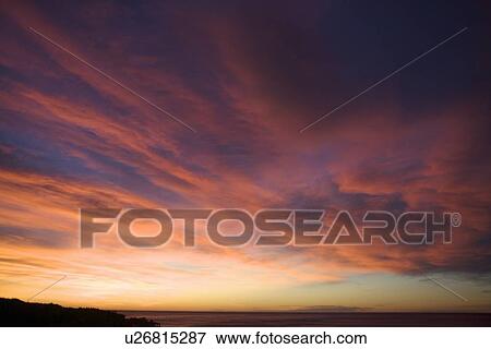 Stock Photo - Colorful clouds in sunset sky. Fotosearch