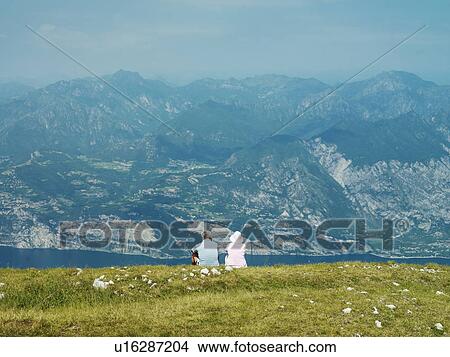 Picture - Couple admiring rural hillside view. Fotosearch
