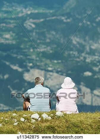 Stock Photography - Couple admiring rural hillside view. Fotosearch