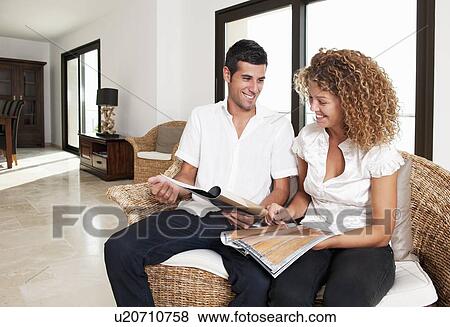 Stock Photo - Couple examining swatches in home. Fotosearch