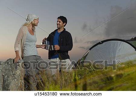 Couple having tea at campsite View Large Photo Image Stock Image - Couple having tea at campsite. Fotosearch