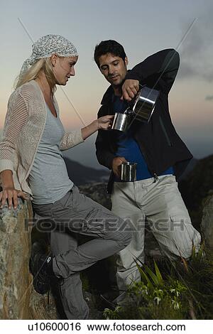 Couple having tea at campsite View Large Photo Image Stock Photograph - Couple having tea at campsite. Fotosearch