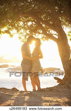 Stock Image - Couple hugging in park. Fotosearch