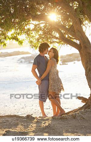 Couple kissing in park View Large Photo Image Stock Photo - Couple kissing in park. Fotosearch