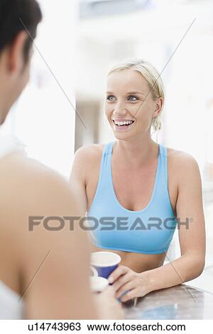 Stock Image - Couple relaxing at cafe together. Fotosearch