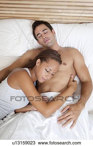 Couple sleeping in bed together View Large Photo Image Stock Image - Couple sleeping in bed together. Fotosearch