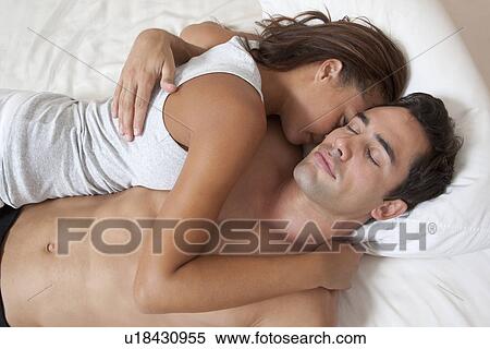 Stock Photography - Couple sleeping in bed together. Fotosearch