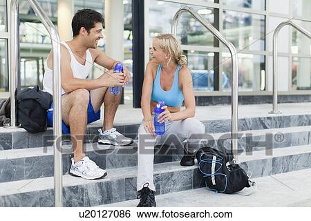 Couple talking on gym steps View Large Photo Image Stock Photograph - Couple talking on gym steps. Fotosearch