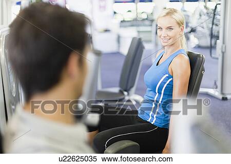 Stock Photography - Couple working out together in gym. Fotosearch