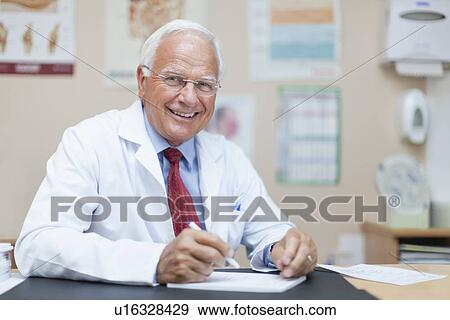Stock Photo - Doctor writing notes in office. Fotosearch