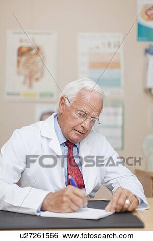 Doctor writing notes in office View Large Photo Image Stock Photograph - Doctor writing notes in office. Fotosearch