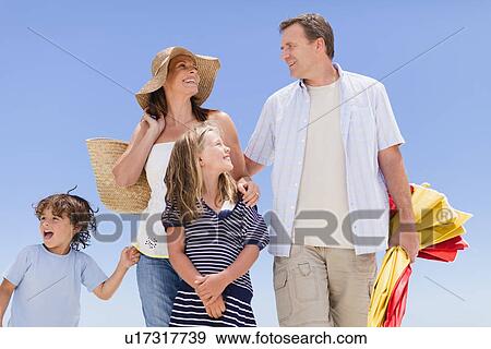 Family carrying beach gear outdoors View Large Photo Image Stock Photo - Family carrying beach gear outdoors. Fotosearch