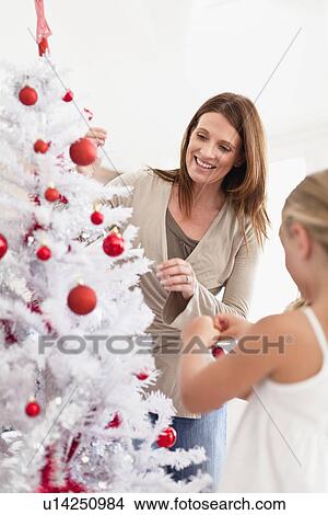 Family decorating Christmas tree View Large Photo Image Picture - Family decorating Christmas tree. Fotosearch
