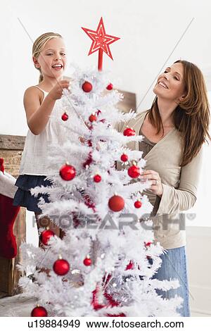Family decorating Christmas tree View Large Photo Image Stock Photo - Family decorating Christmas tree. Fotosearch