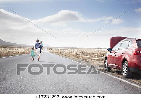 Family leaving broken down car on road View Large Photo Image Stock Photo - Family leaving broken down car on road. Fotosearch