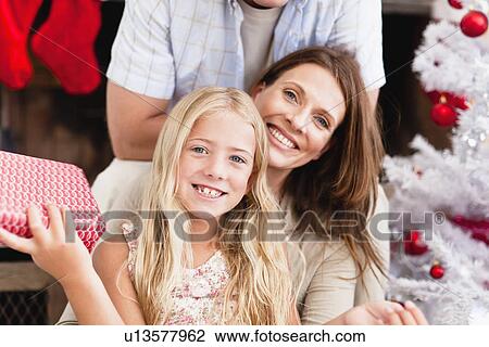 Family smiling with Christmas gifts View Large Photo Image Stock Image - Family smiling with Christmas gifts. Fotosearch