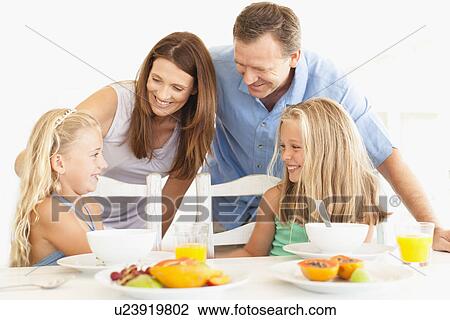 Family talking at breakfast table View Large Photo Image Stock Image - Family talking at breakfast table. Fotosearch