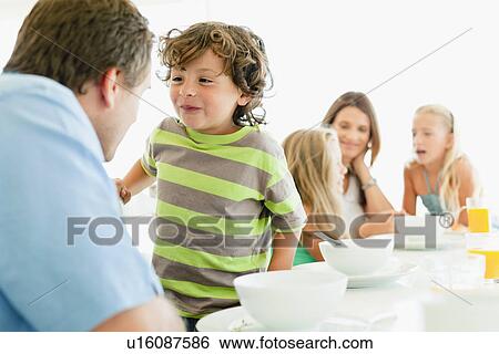 Family talking at breakfast table View Large Photo Image Stock Photograph - Family talking at breakfast table. Fotosearch